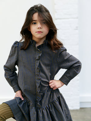 Purple check girls dress with gathered drop waist, ruffled trim down the chest and a high neck ruffled  collar. By Ketiketa