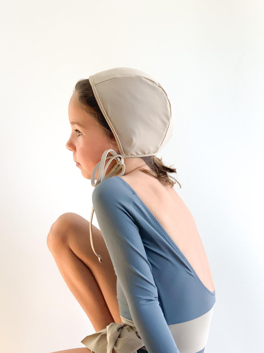 girl wearing unisex sustainable swim bonnet by Casa Blue Swim