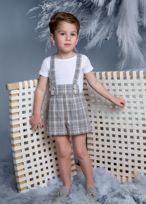 Belati kids spring summer pleated overalls for boys and girls. A little boy is wearing overalls in a blue plaid print.