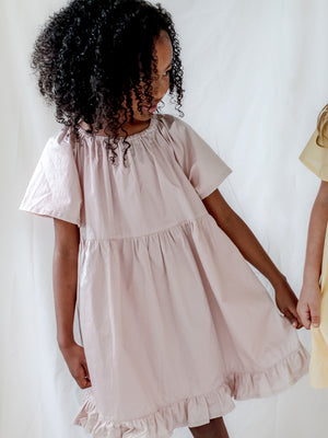 Girl wearing a Dusty Pink Dress With Bell Sleeves, Gathered Neckline, Ruffle Hem and Flowy Silhouette 